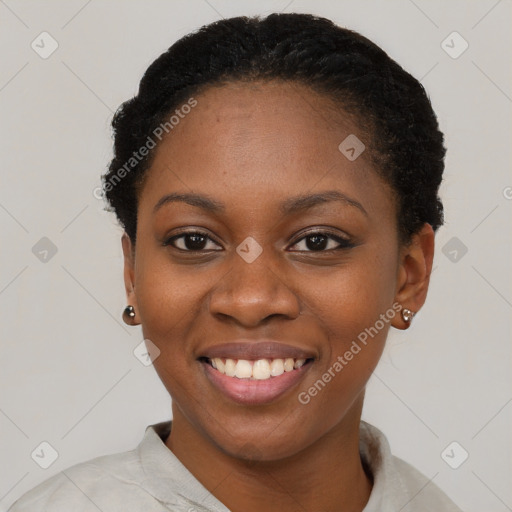 Joyful black young-adult female with short  brown hair and brown eyes