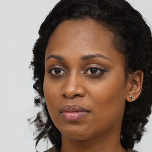 Joyful black young-adult female with medium  black hair and brown eyes