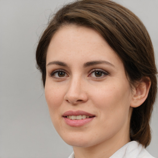 Joyful white young-adult female with medium  brown hair and brown eyes