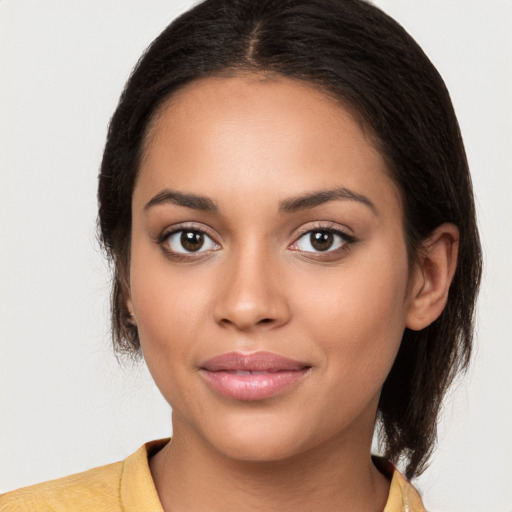 Joyful latino young-adult female with long  brown hair and brown eyes