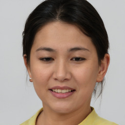 Joyful asian young-adult female with short  brown hair and brown eyes