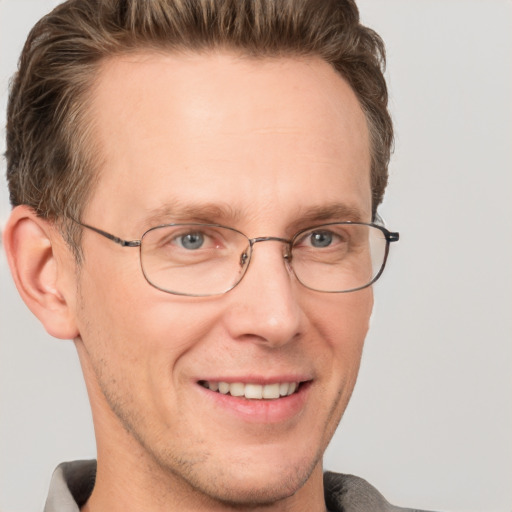 Joyful white adult male with short  brown hair and grey eyes