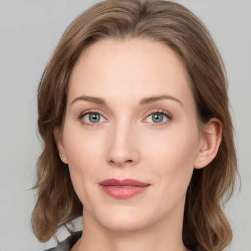 Joyful white young-adult female with medium  brown hair and blue eyes