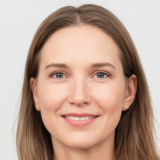 Joyful white young-adult female with long  brown hair and grey eyes