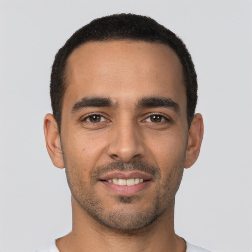 Joyful latino young-adult male with short  black hair and brown eyes