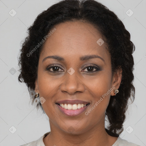 Joyful black adult female with medium  brown hair and brown eyes