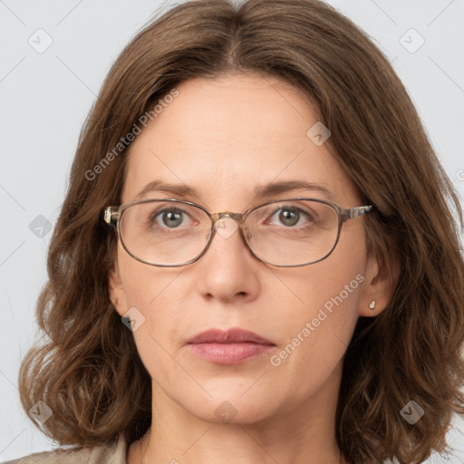 Joyful white adult female with long  brown hair and green eyes