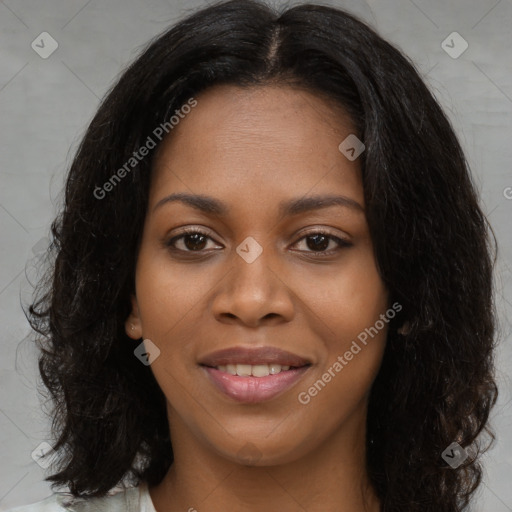 Joyful black young-adult female with long  black hair and brown eyes