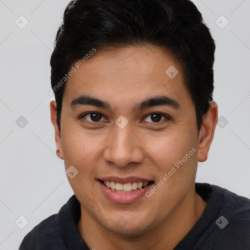 Joyful latino young-adult male with short  brown hair and brown eyes