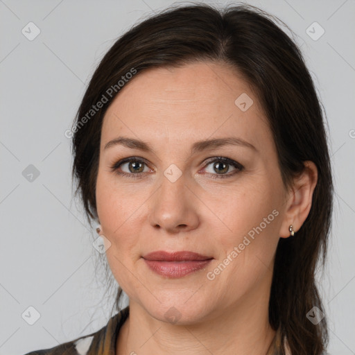 Joyful white adult female with medium  brown hair and brown eyes