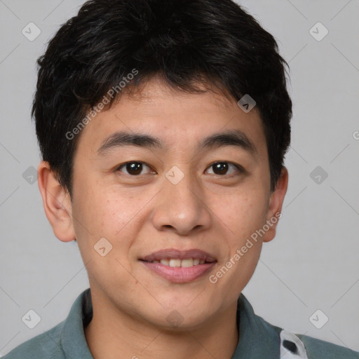 Joyful asian young-adult male with short  brown hair and brown eyes