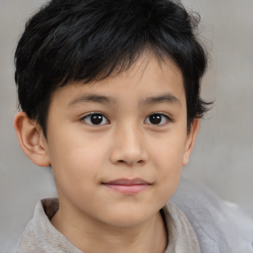 Joyful asian child male with short  brown hair and brown eyes