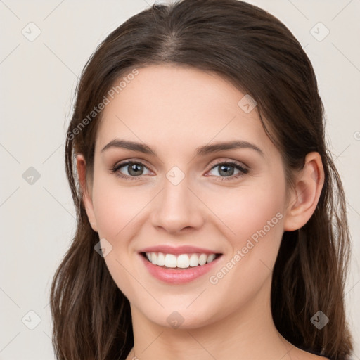 Joyful white young-adult female with long  brown hair and grey eyes