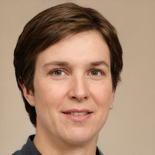 Joyful white adult female with short  brown hair and grey eyes