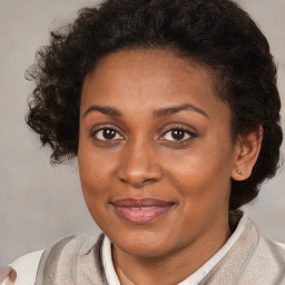 Joyful black adult female with short  brown hair and brown eyes