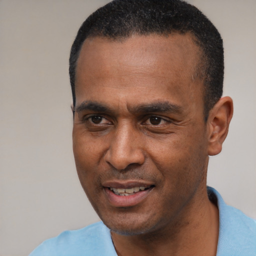 Joyful latino adult male with short  black hair and brown eyes