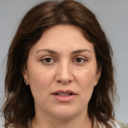 Joyful white adult female with medium  brown hair and brown eyes