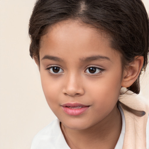 Joyful white child female with long  brown hair and brown eyes