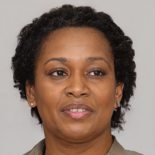 Joyful black adult female with short  brown hair and brown eyes