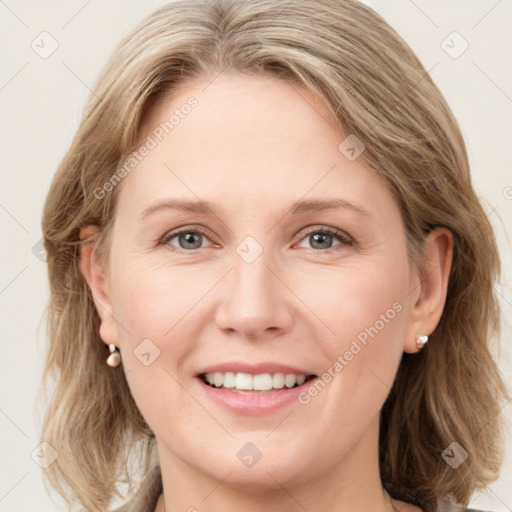 Joyful white young-adult female with medium  brown hair and blue eyes