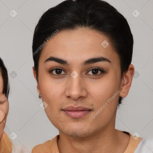 Joyful latino young-adult female with short  brown hair and brown eyes