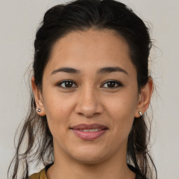 Joyful latino young-adult female with medium  brown hair and brown eyes