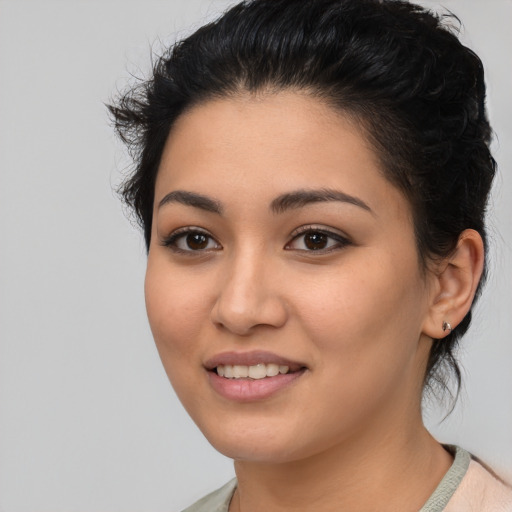 Joyful latino young-adult female with medium  black hair and brown eyes