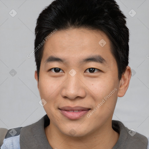 Joyful asian young-adult male with short  black hair and brown eyes