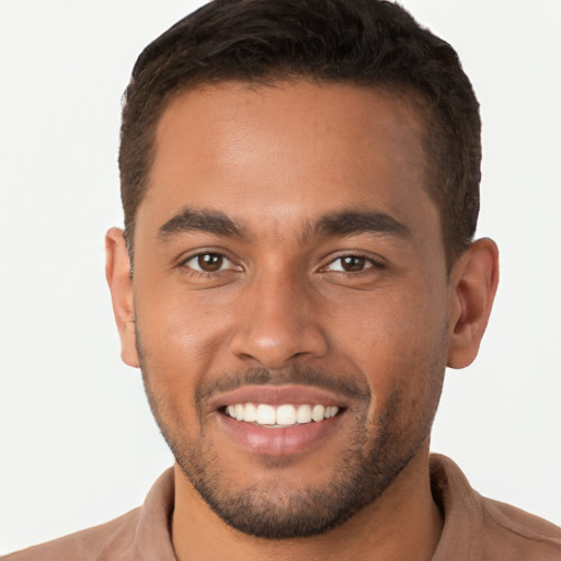 Joyful latino young-adult male with short  brown hair and brown eyes