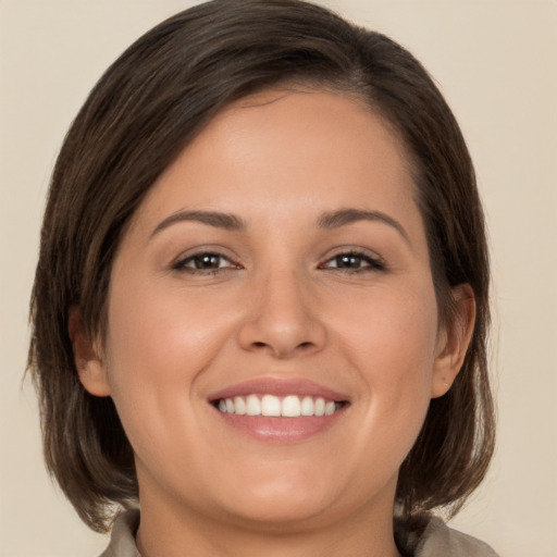 Joyful white young-adult female with medium  brown hair and brown eyes