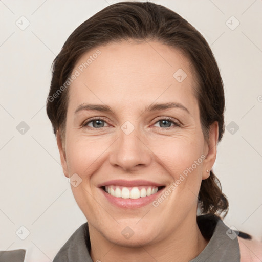 Joyful white adult female with medium  brown hair and grey eyes