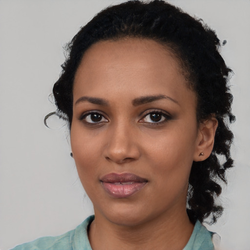 Joyful black young-adult female with medium  black hair and brown eyes