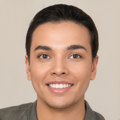 Joyful white young-adult male with short  brown hair and brown eyes