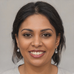 Joyful latino young-adult female with medium  brown hair and brown eyes