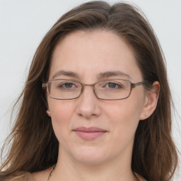 Joyful white adult female with long  brown hair and grey eyes