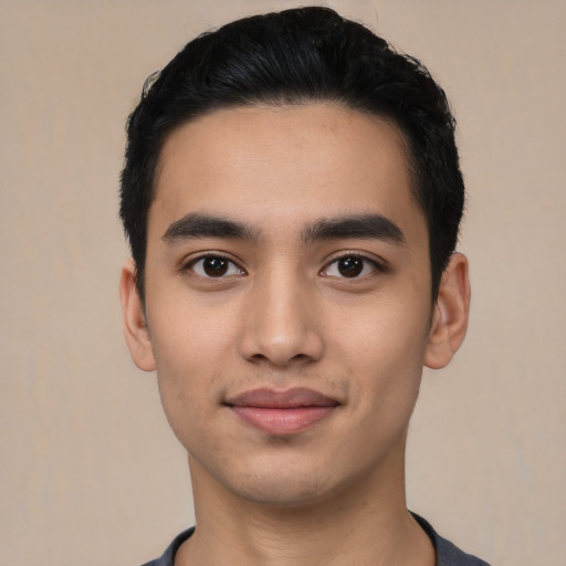 Joyful latino young-adult male with short  black hair and brown eyes