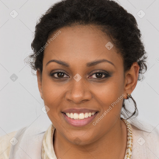 Joyful black young-adult female with short  brown hair and brown eyes