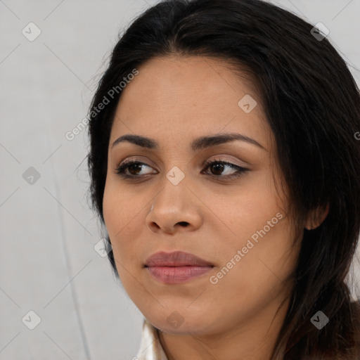 Joyful black young-adult female with long  black hair and brown eyes