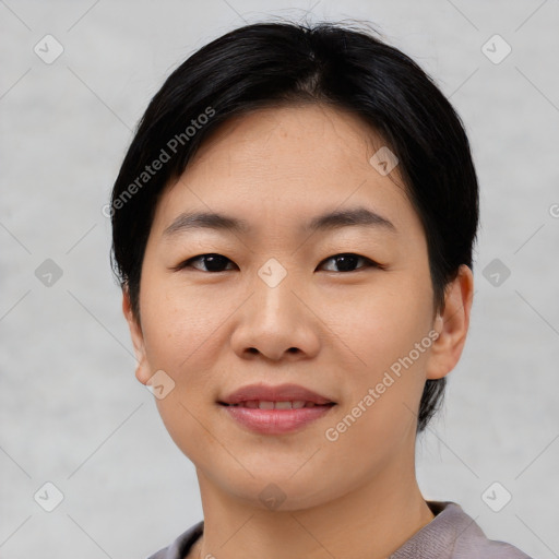 Joyful asian young-adult female with short  black hair and brown eyes