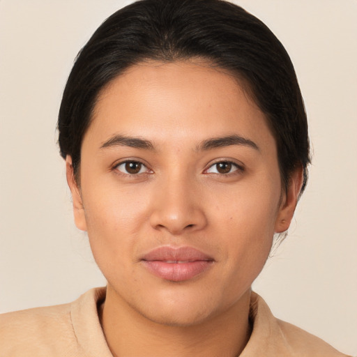 Joyful latino young-adult female with medium  brown hair and brown eyes