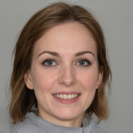 Joyful white young-adult female with medium  brown hair and blue eyes