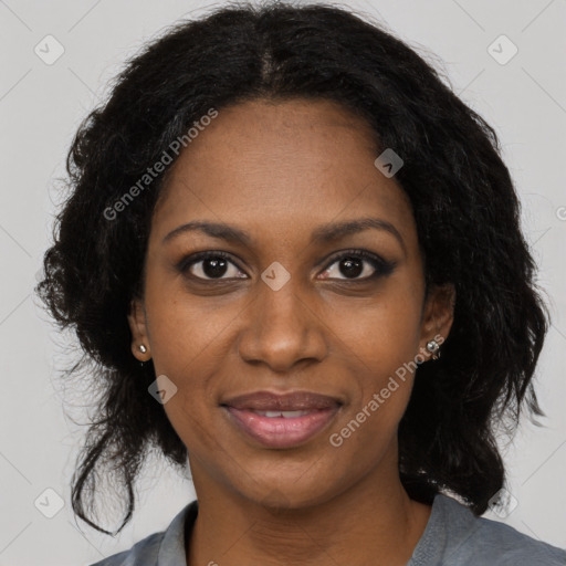 Joyful black young-adult female with long  black hair and brown eyes