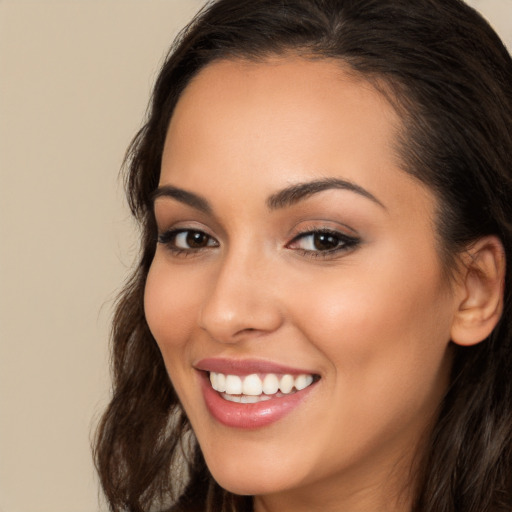 Joyful white young-adult female with long  brown hair and brown eyes