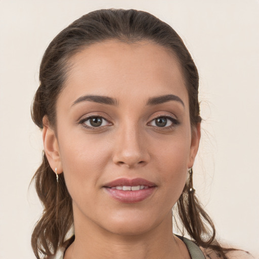 Joyful white young-adult female with long  brown hair and brown eyes