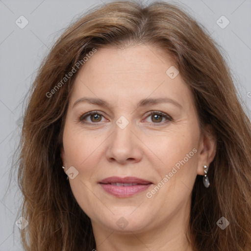 Joyful white adult female with long  brown hair and brown eyes