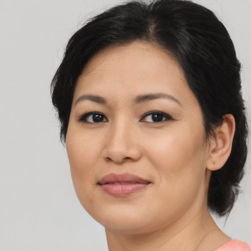 Joyful asian young-adult female with medium  black hair and brown eyes