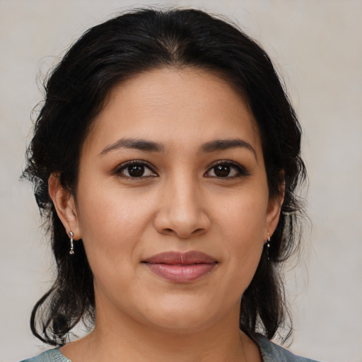 Joyful latino young-adult female with medium  brown hair and brown eyes