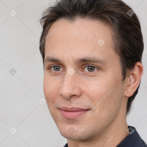 Joyful white adult male with short  brown hair and brown eyes