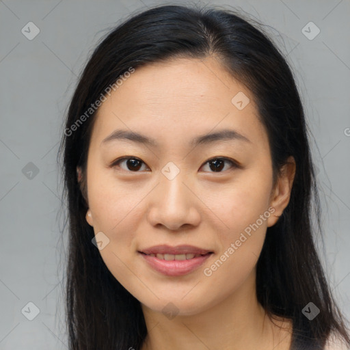 Joyful asian young-adult female with long  brown hair and brown eyes