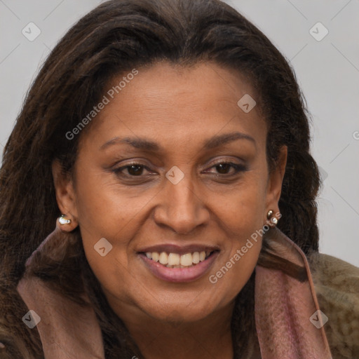 Joyful black adult female with long  brown hair and brown eyes